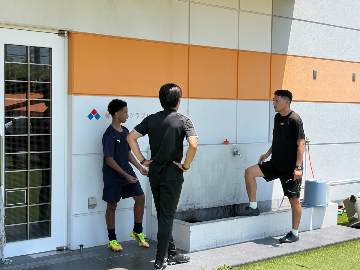 Staff talking with international player at a club facility