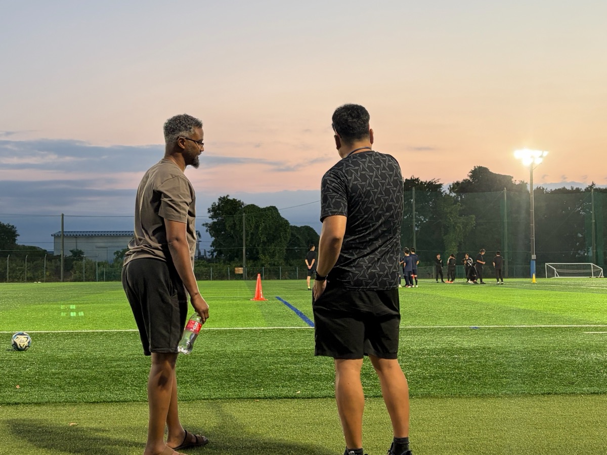 Watching youth football training at sunset from the sideline in Japan
