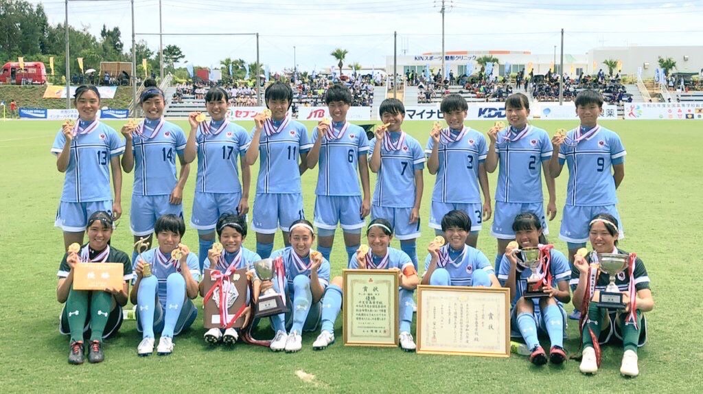 Women's team with medals and trophies